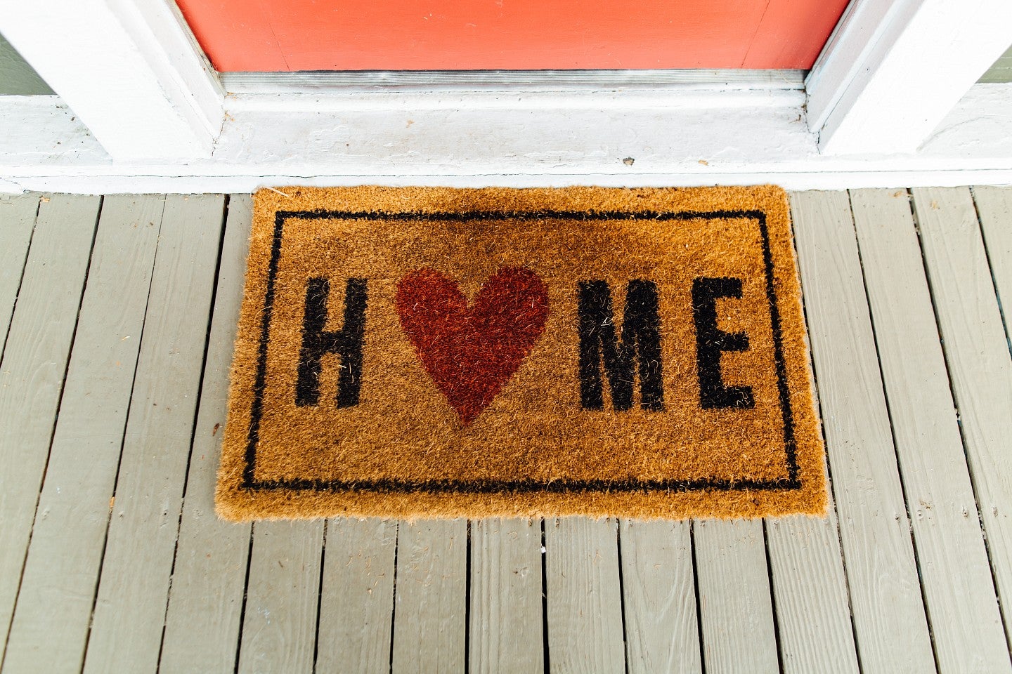 Home doormat with a heart for the "O". Photo by Kelly Lacy from Pexels
