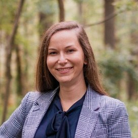 Katie Lucca smiling with trees in the background