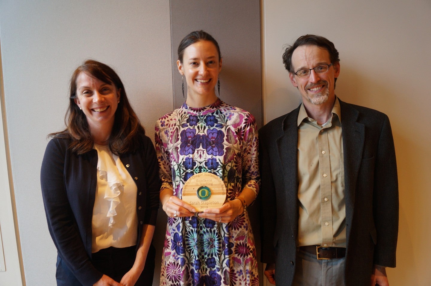 Excellence in Teaching 2019 winner Sarah Stapleton holds her award alongside TEP representatives.