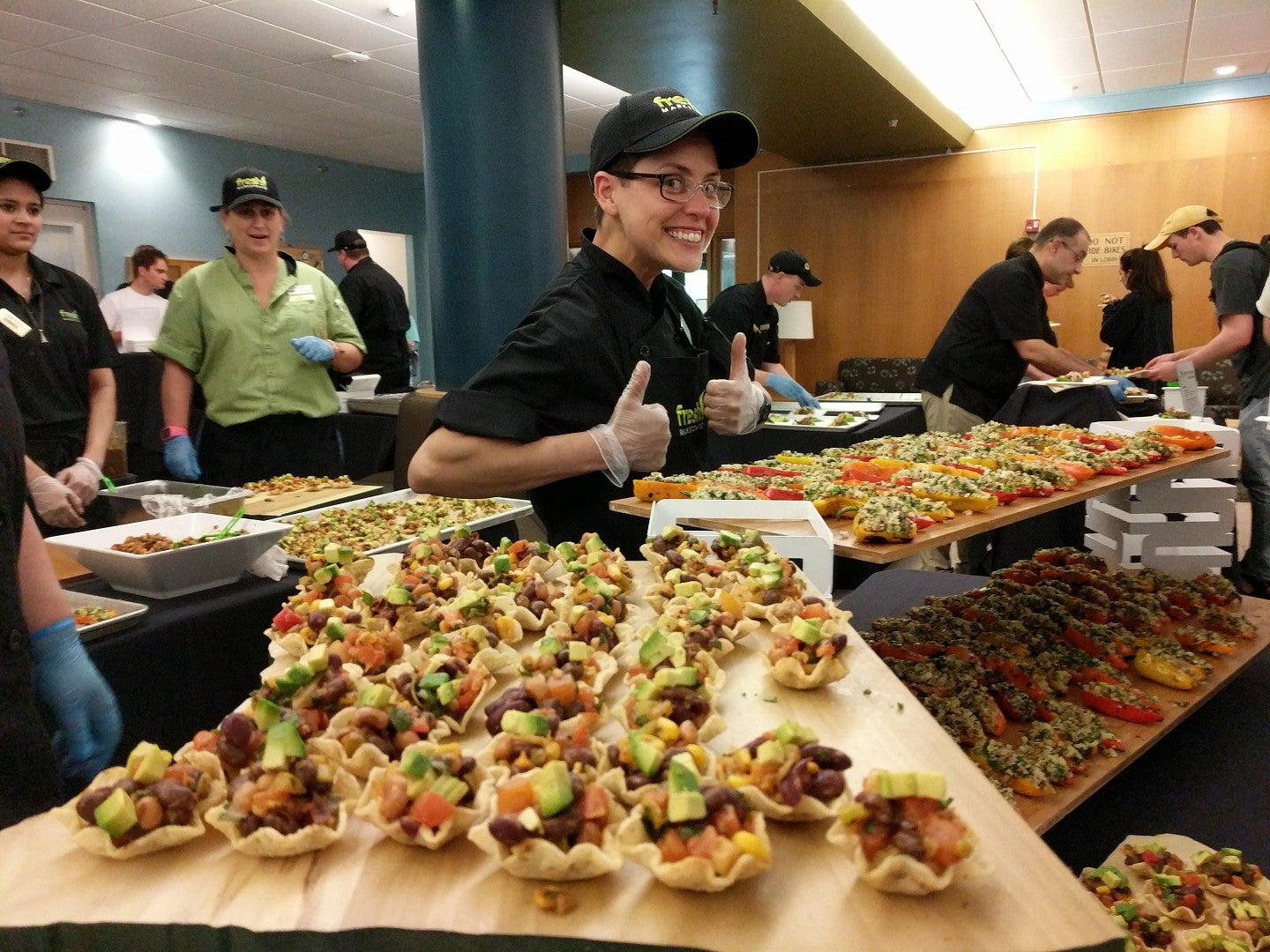 Chef gives thumb's up while showcasing her blackbean "caviar" bites