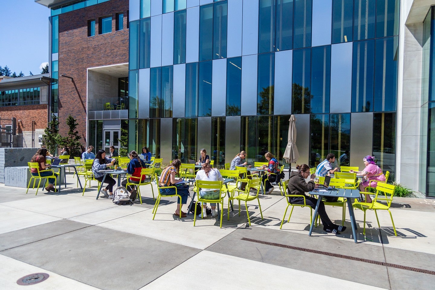 Images of campus taken April 24, 2019. Students stitting outside of the EMU at tables.