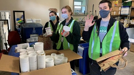 Student Sustainability Ambassadors help sort collected plastic materials for recycling.