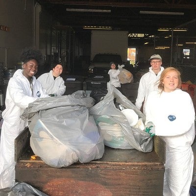 Sustainability ambassadors sort trash as part of a waste audit.