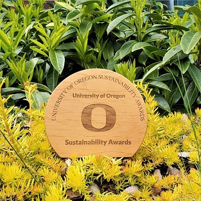 UO Sustainability Award on a bed of plants.