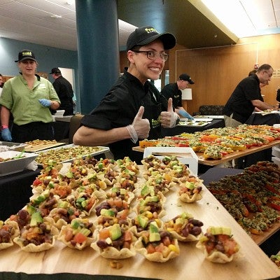 Chef gives thumb's up while showcasing her blackbean "caviar" bites