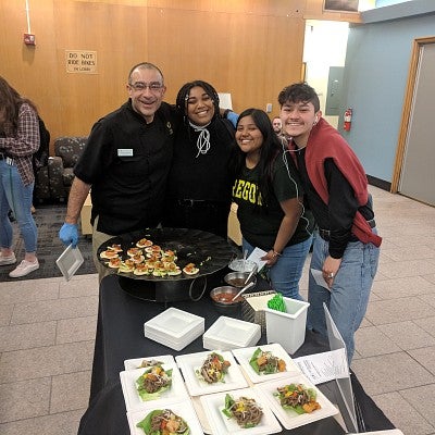 Chef poses with students tasting his low carbon footprint bite
